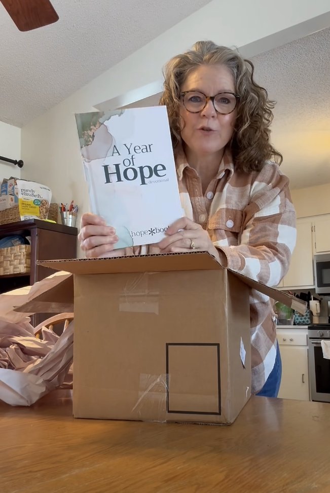 A reader holding A Year of Hope