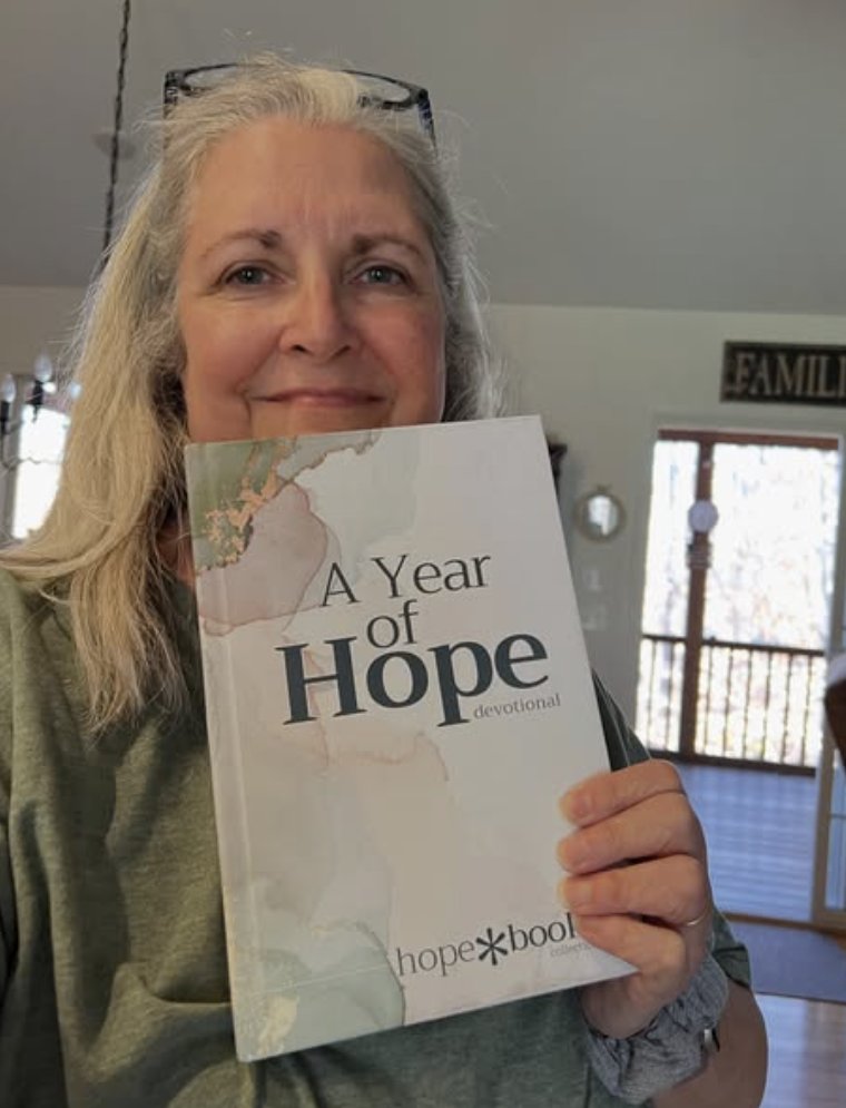A reader holding A Year of Hope